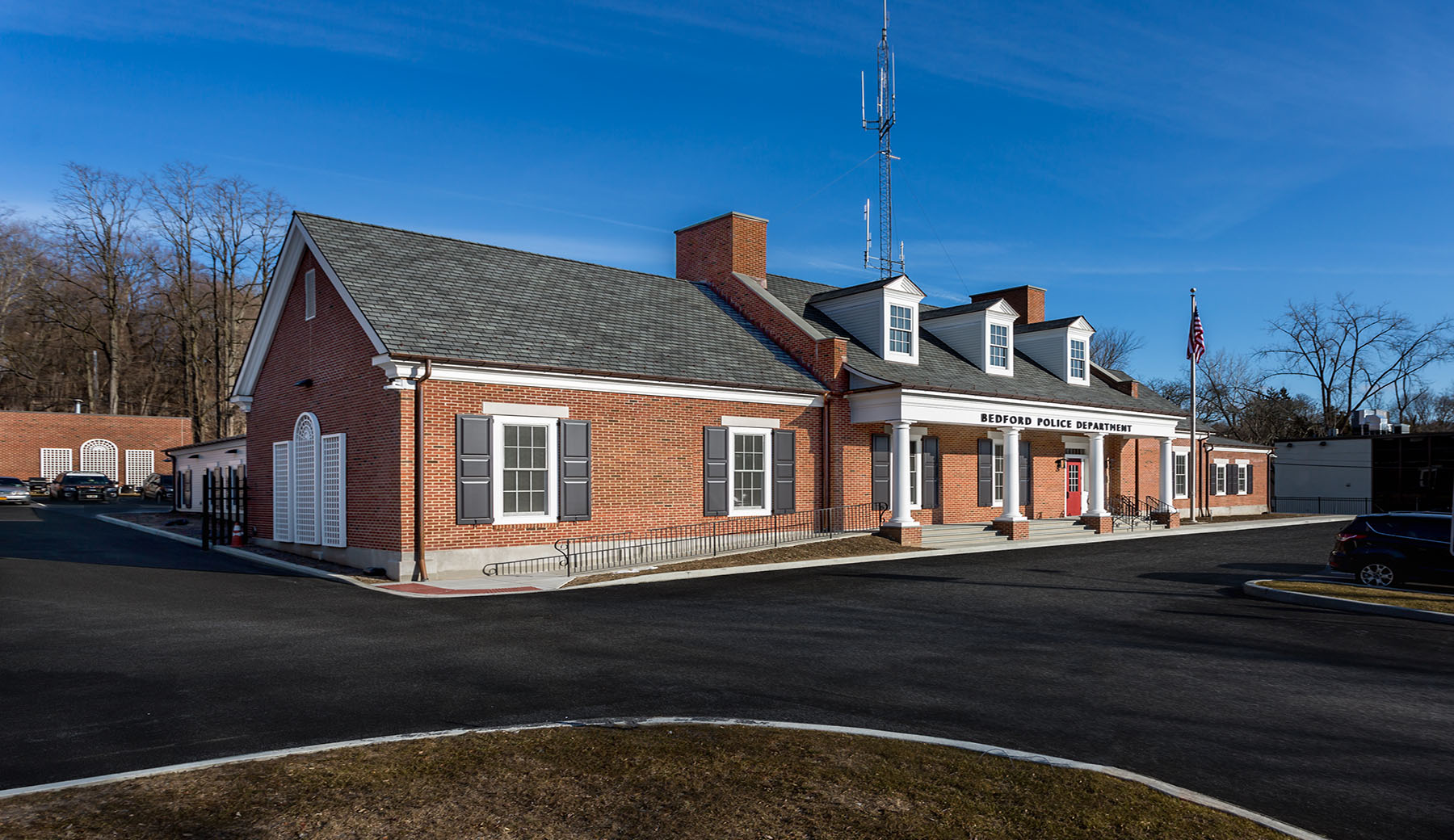 Exterior View of Bedford Police Station (Completed):  A complete renovation and expansion of a former industrial building meets the needs of a growing police department. Architectural details are sympathetic to the Colonial Style of the adjacent Bedford Town Hall.