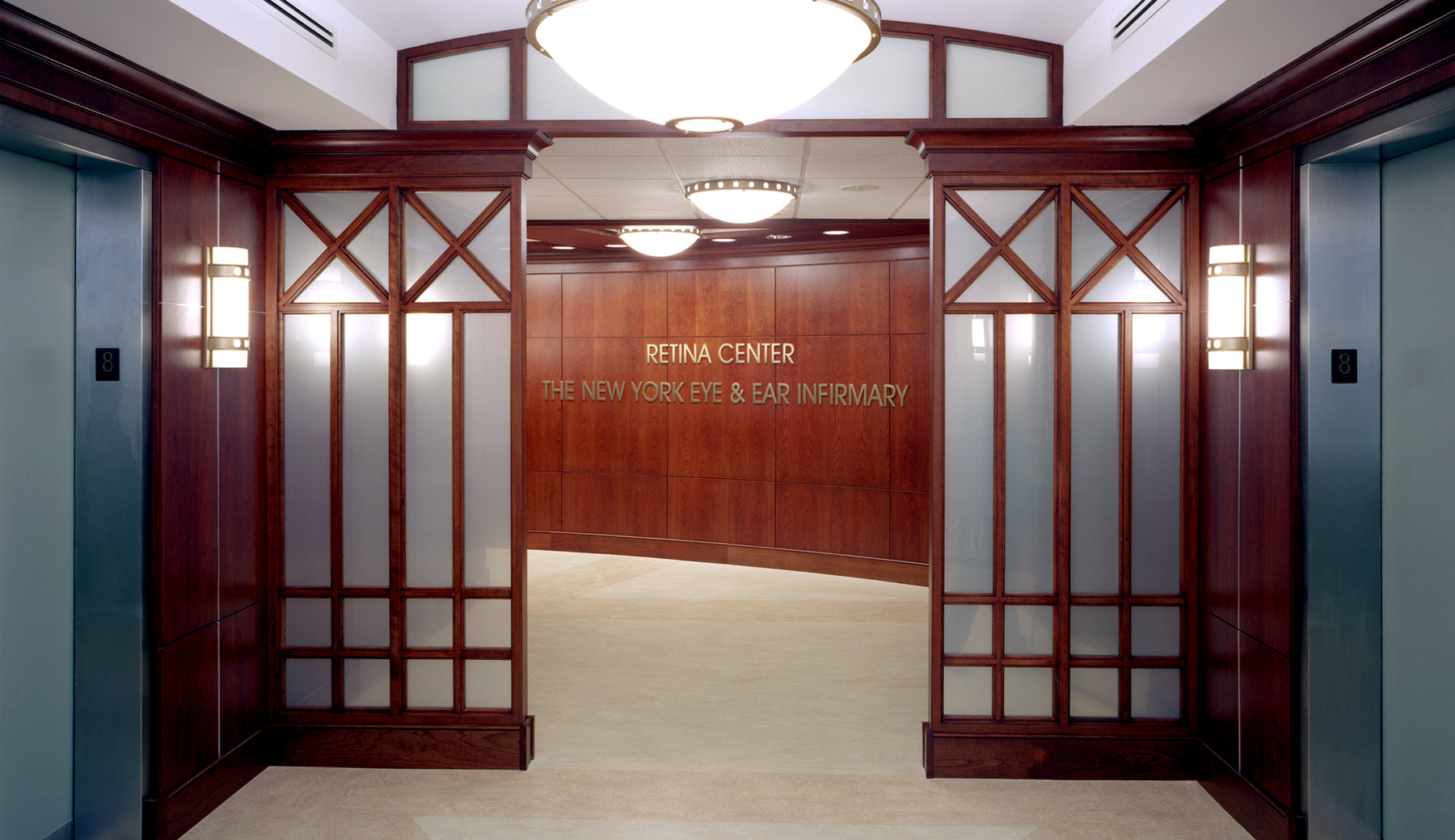 The New York Eye and Ear Infirmary is an Eye Trauma Center for New York City. Warm cherry wood with classical metal accents and elegant floor patterns provide a calming atmosphere.