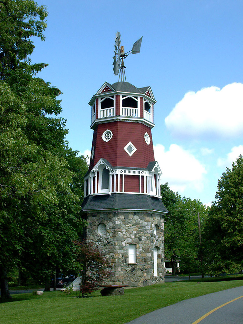 Restored windmill with a stone base.