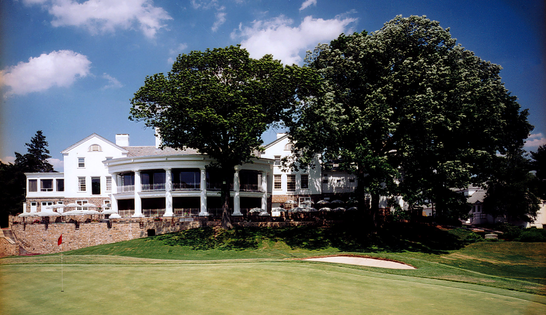 Lothrop Associates expanded the Scarsdale Gold Club dining areas and renovated the lockers rooms.  The view from 18th green shows the large portico and deck with columns and exterior patio.  